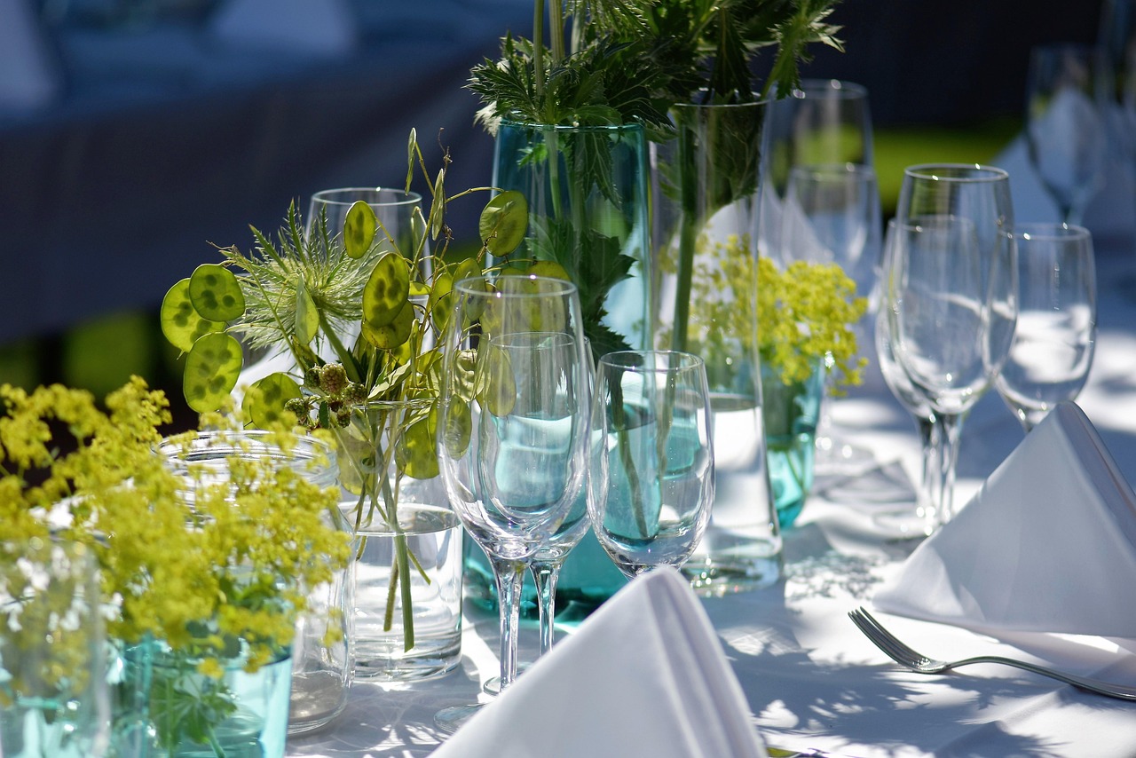 Houten tuinmeubels omringd door groene planten.